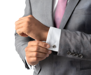 A businessman adjusts his cufflink, dressed impeccably in a gray suit and pink tie, close-up shot.