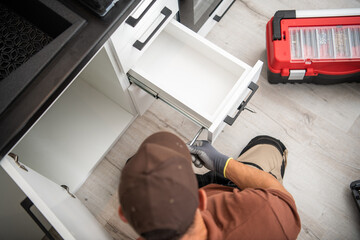 Fototapeta premium Renovation Work on Kitchen Cabinets With a Focus on Drawer Installation in a Modern Space