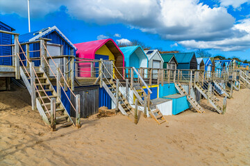 A view along a line of colourful two storey beach huts at the town of Abersoch, Wales in springtime