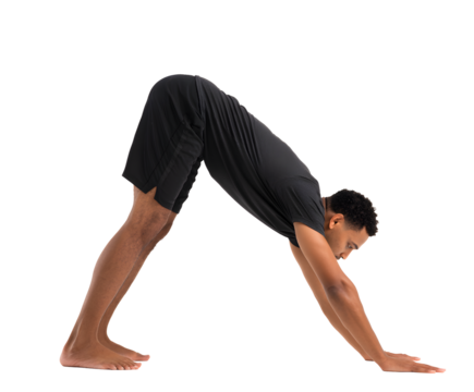 An athletic man performs the downward-facing dog yoga pose, focusing on fitness and flexibility. - Powered by Adobe