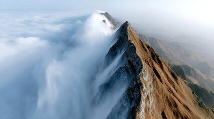 Majestic mountain peak rises above clouds in a breathtaking landscape during early morning hours
