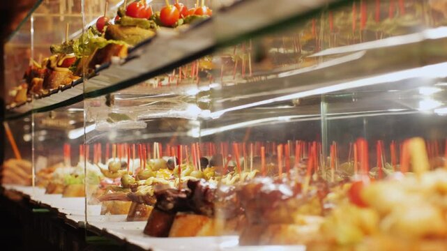 Italian or Spanish restaurant with traditional tapas pinchos food, Spanish cuisine, delicious tapas and cheese plate, bruschetta with cheese, olives dry tomatoes tasty sandwich bar appetizer, buffet