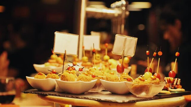 Italian or Spanish restaurant with traditional tapas pinchos food, Spanish cuisine, delicious tapas and cheese plate, bruschetta with cheese, olives dry tomatoes tasty sandwich bar appetizer, buffet