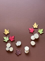 Autumn theme illustration. Maple colored leaves and wood on brown background. Place for writing text