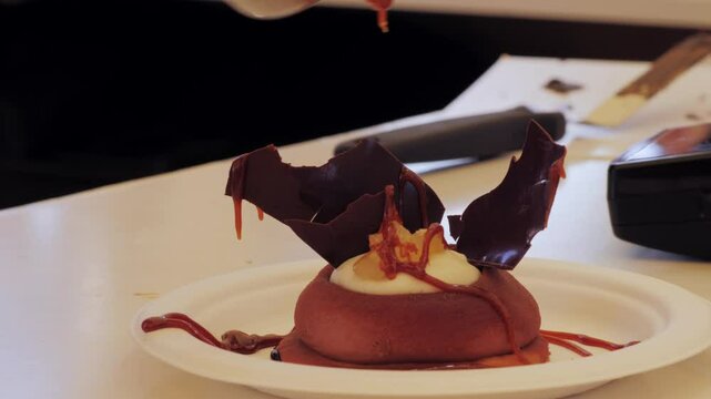 Mousse orange cake, creamy dessert close-up. Almond dacquoise, raspberry confit, crispy layer with caramelized hazelnuts and raspberry powder, mousse based on bitter chocolate.