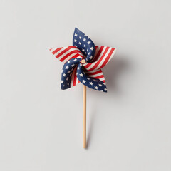 A paper pinwheel in American flag colors. Clean composition is ideal for patriotic designs and festive U.S. holiday themes.