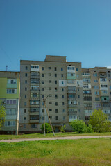 Soviet Style Apartment Building Facade with Balconies and Blue Sky
