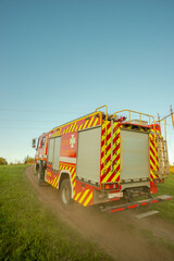 Rear View of Fire Truck '101' with Yellow and Red Stripes in Field