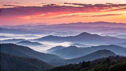 Fototapeta premium Sunrise over misty mountain ranges