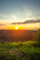 Golden Sunset Over Freshly Plowed Farmland