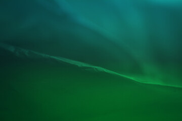 Extreme close up of green empty plastic bag background. The plastic surface is wrinkly and tattered...
