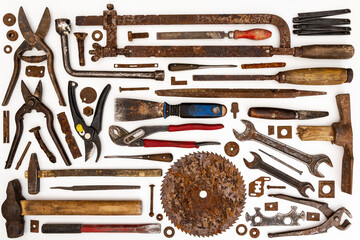 Flat lay of old hand tools on white background. Large collection of various rusty tools and bits arranged on white.
