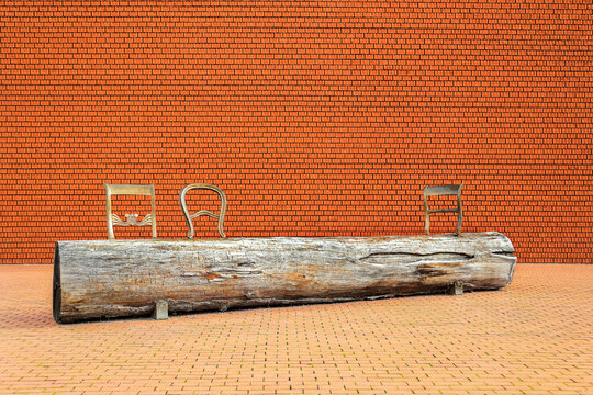 Weil am Rhein, Germany - October 23. 2022: The resting place made of classic chair backs and a wood log for visitors at the Schaudepot of the Vitra Campus, which is a renown Swiss furniture company.