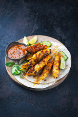 Authentic artisan Sate Ayam- Grilled chicken satay sate skewers with flatbread  and fresh cucumber