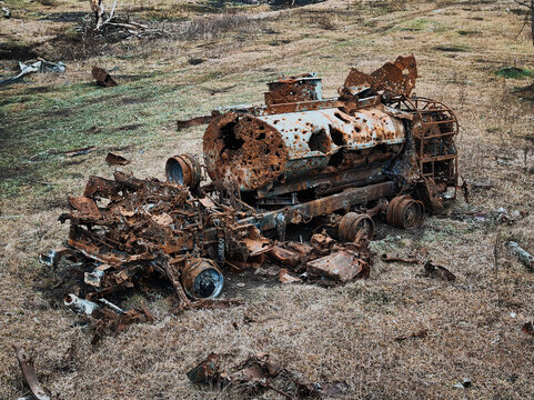 Devastated vehicle remains on a battle-scarred field