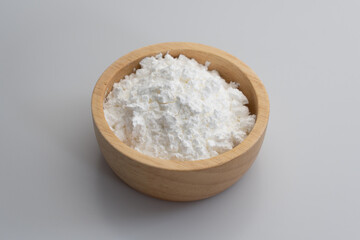 Close-up of tapioca starch or flour powder in spoon with white background