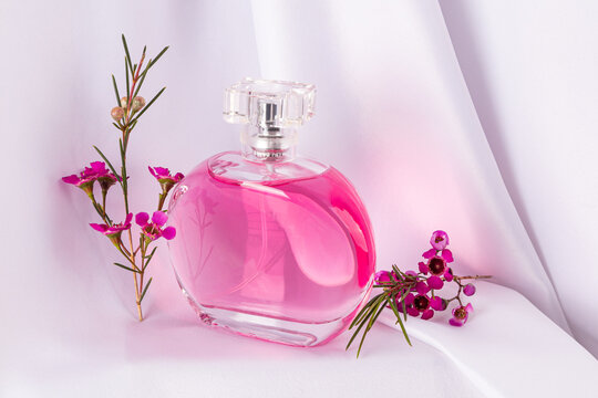Perfume bottle with vibrant pink floral arrangement