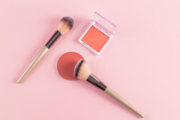 Compact blush and brushes on pink background