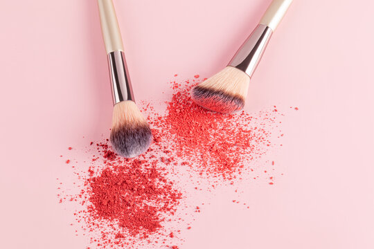 Makeup blush with brushes on soft pink background