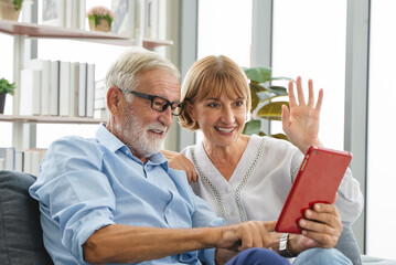 mature couple use touchpad device talk with friend.