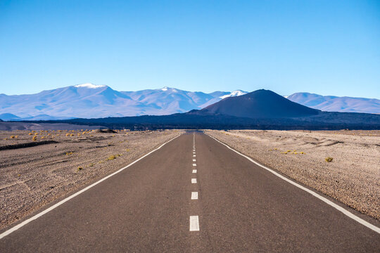 Clear road through La Puna, Argentina flanked by mountains