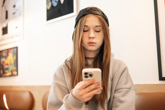 Teenage girl using smartphone indoors