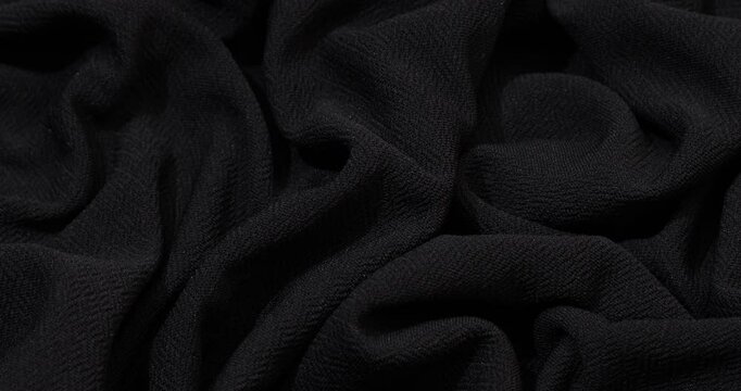 Detailed closeup of black cloth with gentle folds