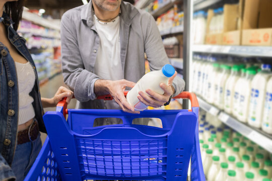 Couple shopping for groceries in a supermarket aisle