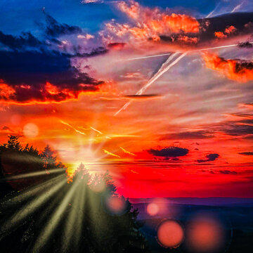 Red sunset in the mountains sunrays sky clouds