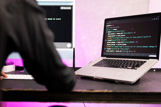 Profile side view of nice man wearing professional shirt professional expert html database structure screen at workplace station. Man is creating an algorithm for a website.