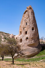 Uchisar Castle or Kalesi, a unique cave building, carved from volcanic rock at the highest point of...