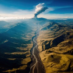 Majestic aerial view of a volcanic eruption with a plume of smoke rising above the rugged mountain landscape and river valley under a bright sunny sky atmosphere.