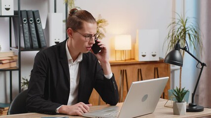 Angry young businessman CEO in formal suit making smartphone online conversation call at home office. Upset stylish freelancer man talking to colleague after analyzing financial report mistake problem - Powered by Adobe