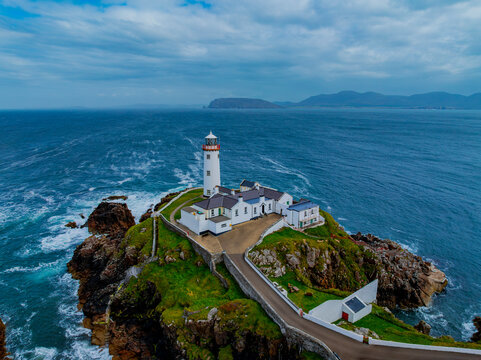 Aerial view of fanad lighthouse on the beautiful coastline with crashing waves and rocky landscape, Fanad, County Donegal, Ireland.