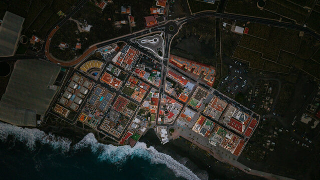 Aerial view of puerto naos town with beach, buildings, and banana fields at blue hour, La Palma Island, Canary Islands, Spain.
