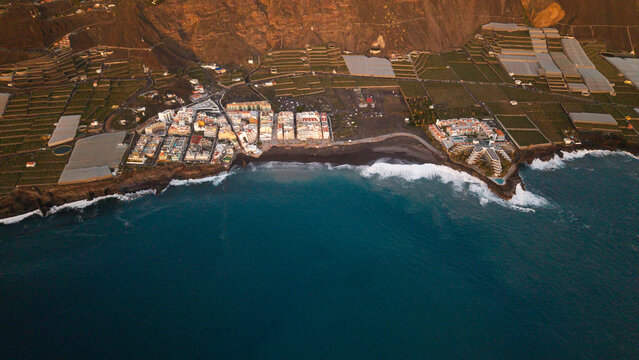 Aerial view of puerto naos town with banana fields and volcanic coastline, La Palma Island, Canary Islands, Spain.