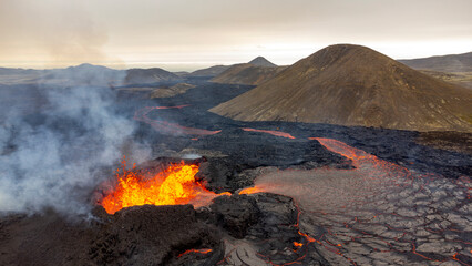 Aerial view of the majestic Volcano Litli-Hrutur with flowing lava and smoke, Grindavik, Sudurnes, Iceland.