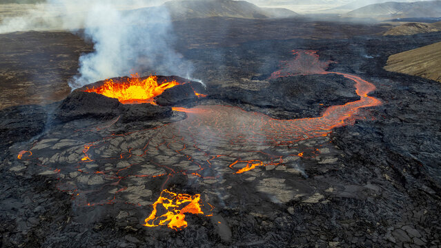 Aerial view of Volcano Litli-Hrutur with flowing lava and smoke, Grindavik, Sudurnes, Iceland.