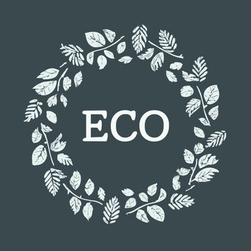 Ecological logo &ldquo;ECO&rdquo; with white leaves and branches on a dark gray background