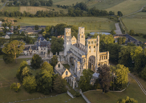 Aerial view of the historic abbey ruins surrounded by lush greenery and countryside, Jumieges, Seine-Maritime, France.
