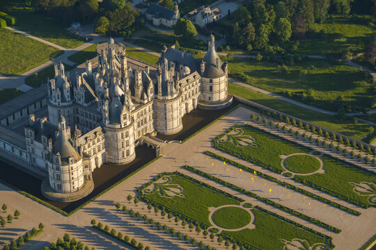 Aerial view of the majestic Chambord Castle surrounded by sculpted French gardens, Loir-Et-Cher, France.