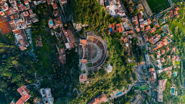 Aerial drone top-down view of Teatro Antico di Taormina during sunrise, Island of Sicily, italy