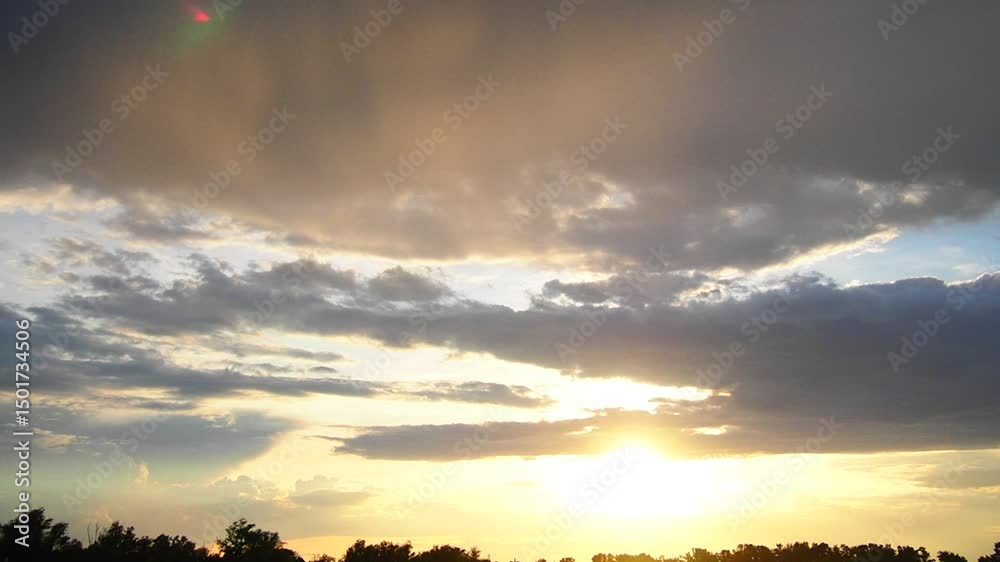 Poster a breathtaking view showcases the golden sun halo glowing vibrantly as it sets behind the horizon. w