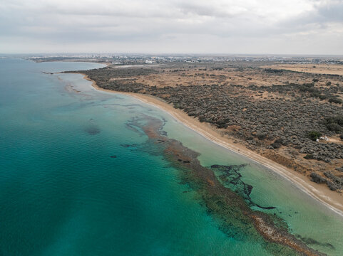 Aerial view of beautiful coastline and serene beach with clear water, Ancient Salamis, Agios Sergios, Famagusta, Turkish Republic of Northern Cyprus.