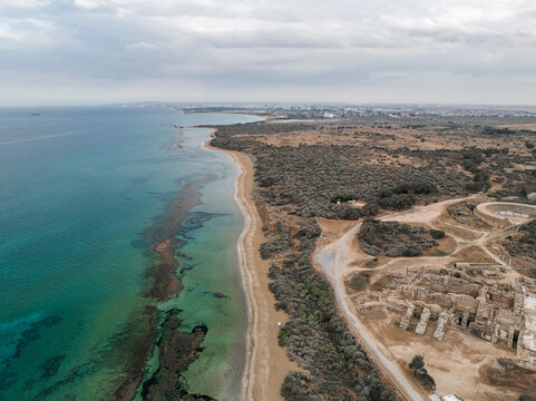 Aerial view of ancient ruins along a sandy beach and tranquil sea, Agios Sergios, Famagusta, Turkish Republic of Northern Cyprus.