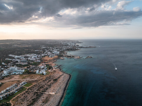 Aerial view of beautiful coastline with tranquil sea and urban buildings, Cyclops Cave, Paralimni, Famagusta, Cyprus.
