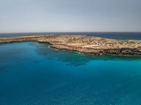 Aerial view of the beautiful blue lagoon with crystal clear water and serene coastline, Cape Greco Peninsula, Agia Napa, Famagusta, Cyprus.