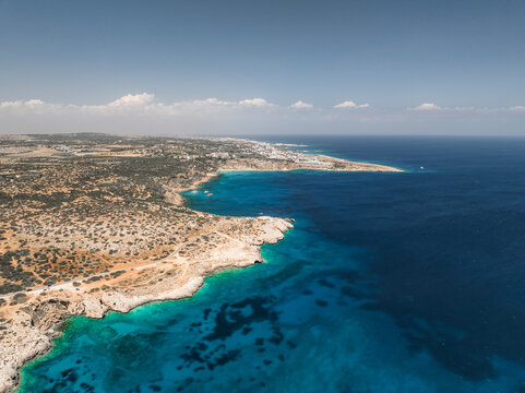 Aerial view of beautiful blue lagoon surrounded by natural coastline, Cape Greco Peninsula, Agia Napa, Famagusta, Cyprus.