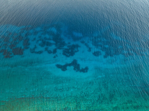 Aerial view of beautiful turquoise ocean with clear sandy shoreline, Cyclops Cave, Paralimni, Famagusta, Cyprus.