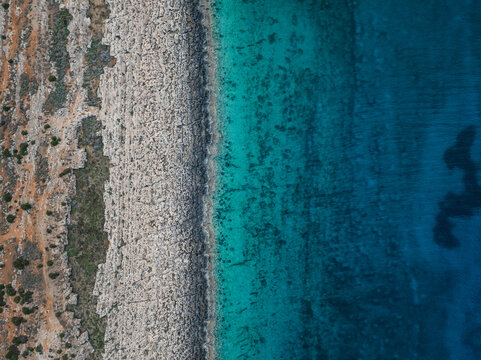 Aerial view of beautiful rocky shore with turquoise clear water and scenic coastline, Cyclops Cave, Paralimni, Famagusta, Cyprus.